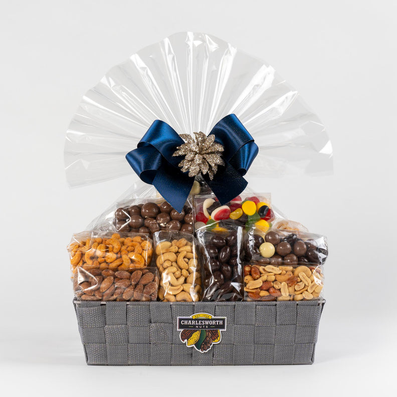 Christmas Gift Basket filled with nuts, lollies and chocolates adorned with a blue ribbon. 