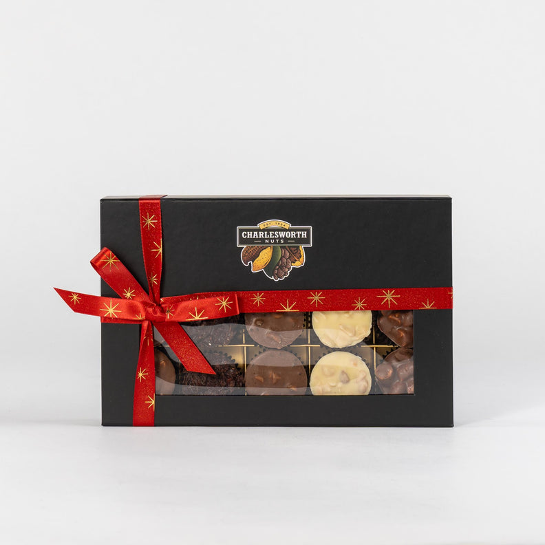 Christmas gift box filled with 15 different chocolates including white, dark and milk chocolate. Wrapped in a Christmas red ribbon.