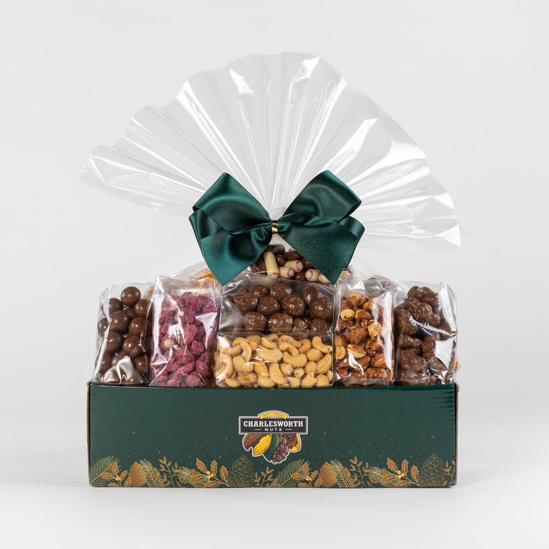 Christmas gift basket beautifully present with nuts and chocolate and  adorned with a green ribbon.