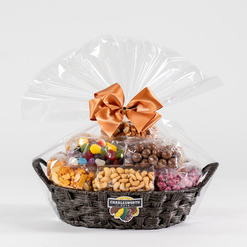 Gift basket filled with chocolates, nuts and lollies adorned with a beautiful bow. 