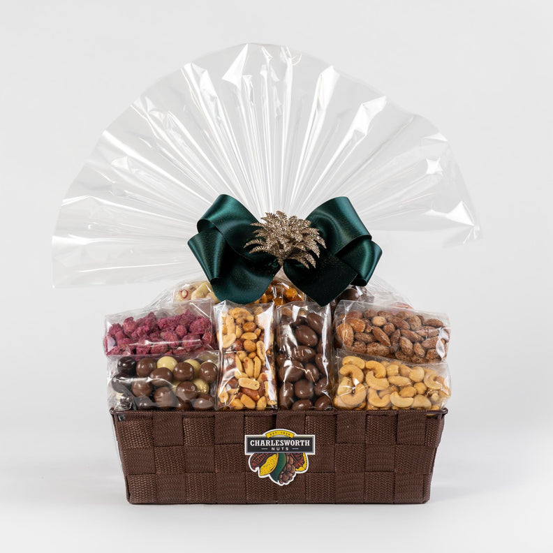 Christmas Gift Basket adorned with green ribbon filled with chocolates and nuts