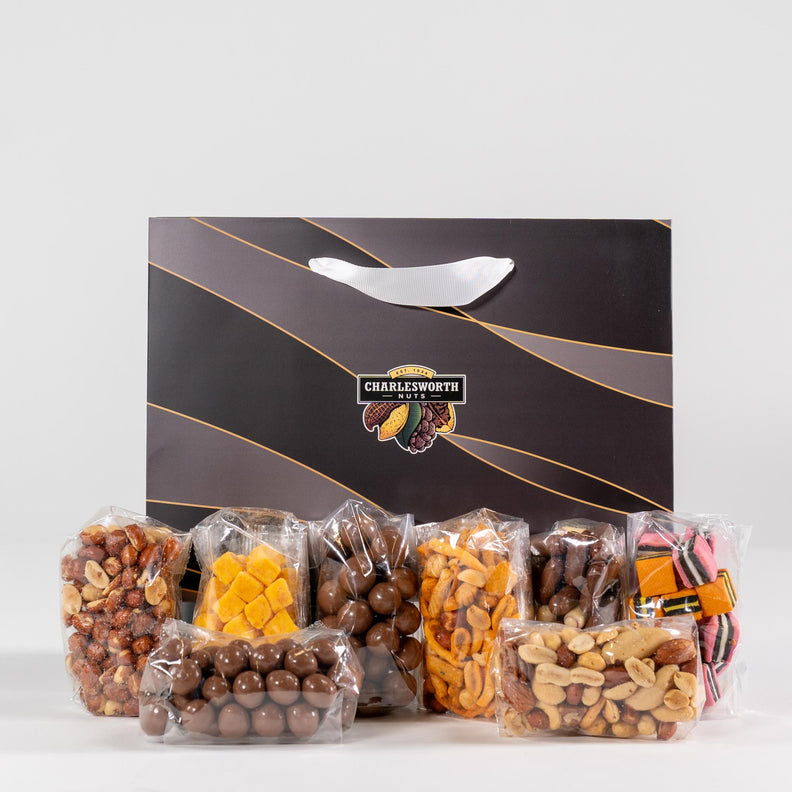 Corporate gift bag filled with beer nuts, chocolate bullets, licorice, nut mix and dried apricots.