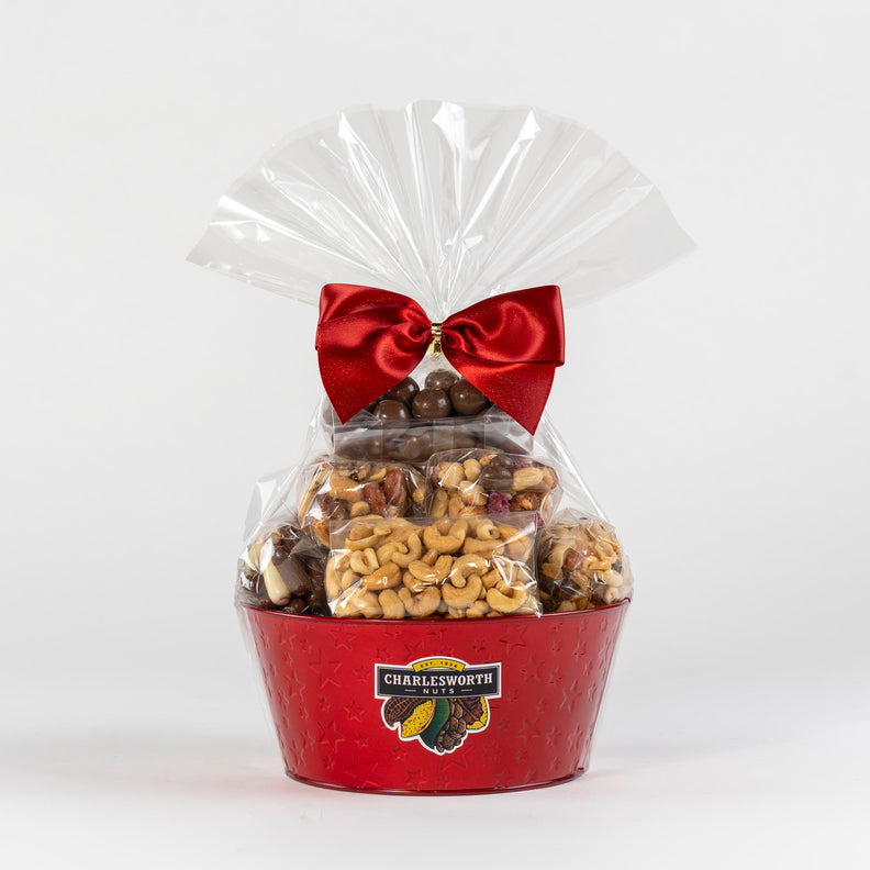 Christmas Gift Basket beautifully presented filled with a red bow and red basket, filled with nuts and chocolates