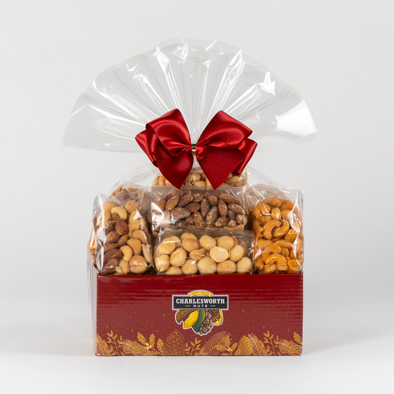 Christmas Gift basket beautifully adorned with a red ribbon and filled with macadamias, almonds, cashews and pecans. 