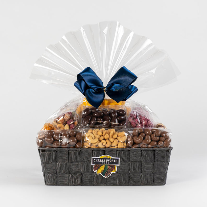 Christmas Gift Basket filled with chocolates and nuts and adorned with a beautiful blue ribbon